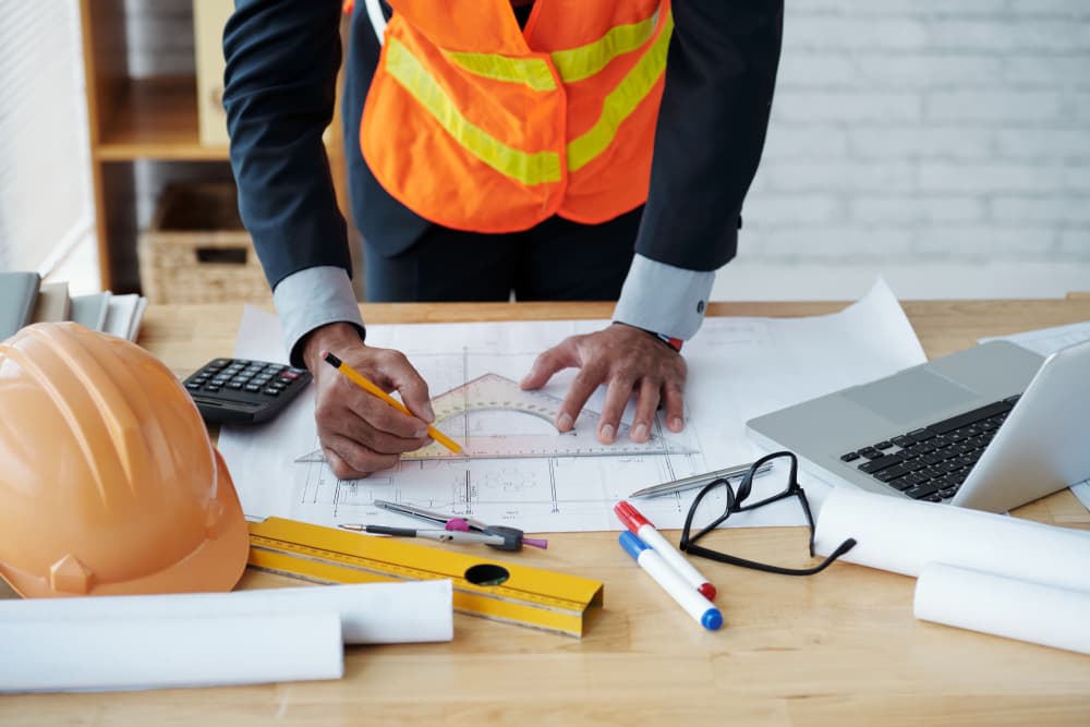 An engineer working through drawings on a site table