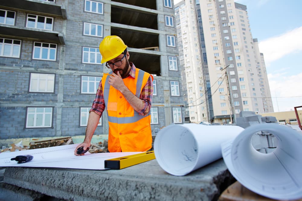 An engineer working through drawings on a site table